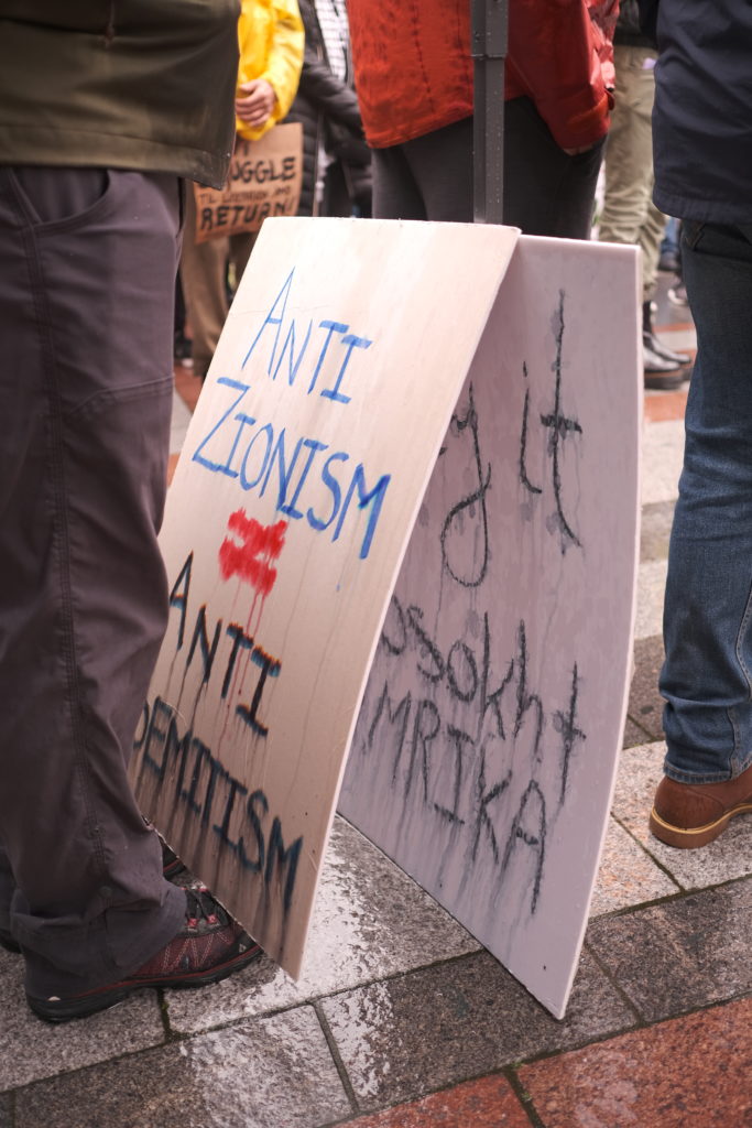 A sign clarifies the stance that anti-zionism is not the same as anti-semetism.