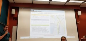 Pic of King County Metro representative discussing slide showing alternate bus routes for viaduct closure