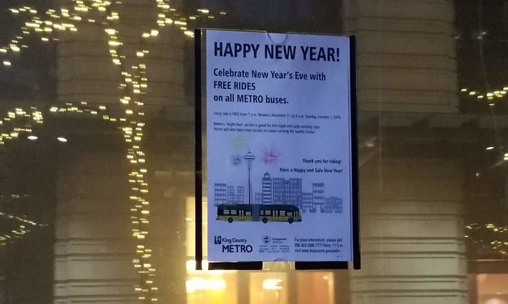 Photo of King County Metro's sign posted inside bus announcing free rides on NYE