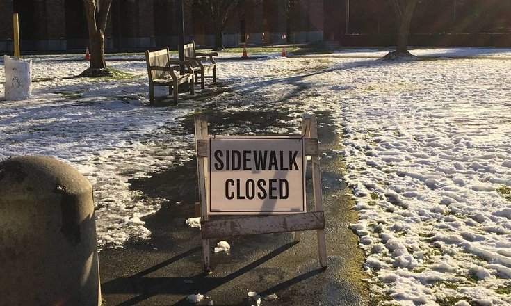 picture of closed sidewalk sign on UW campus near where site of accident
