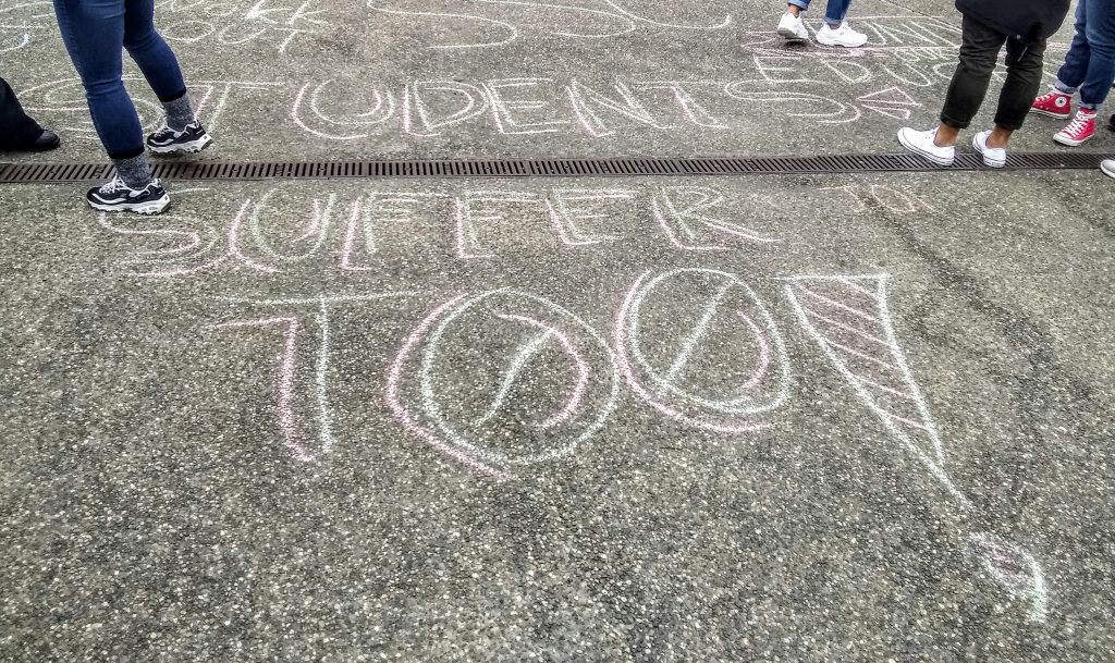 chalk text "students suffer too"