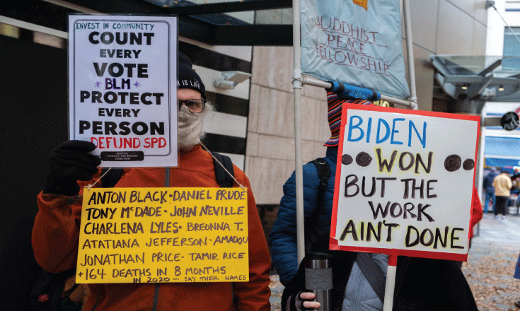 A sign that reads "Biden won but the work ain't done"