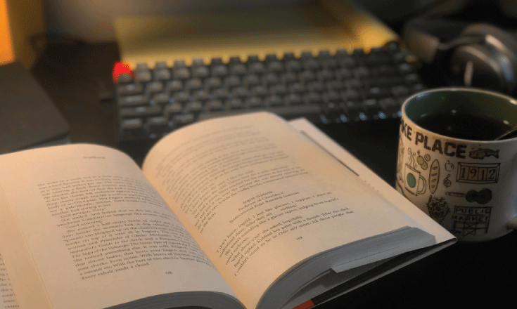 Open book with coffee and keyboard