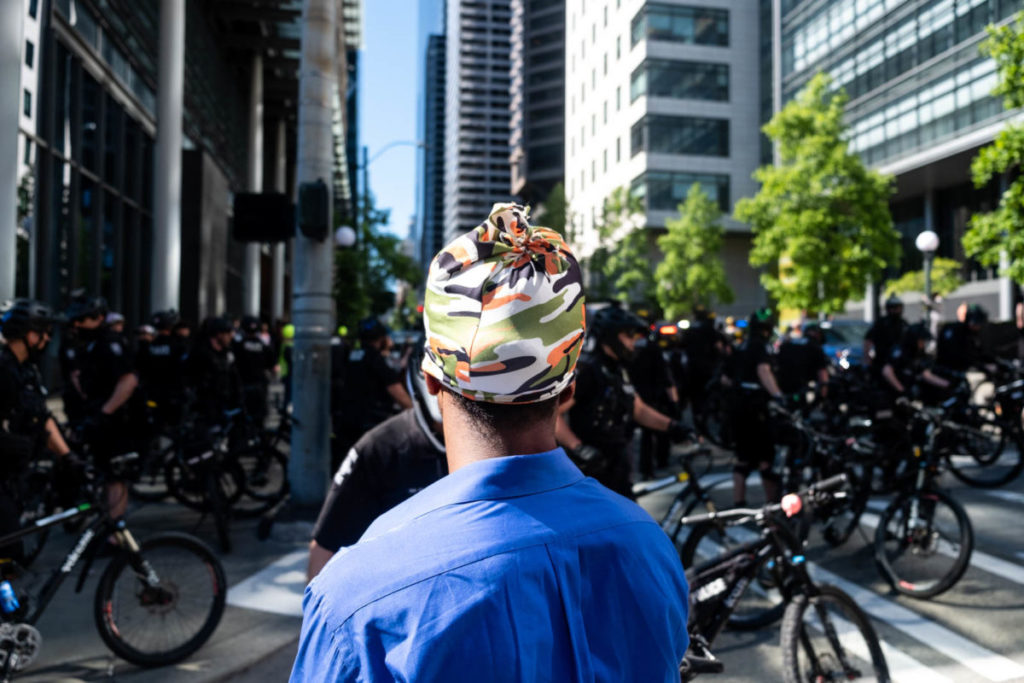 A lone protestor stares down dozens of police officers who had just made several arrests