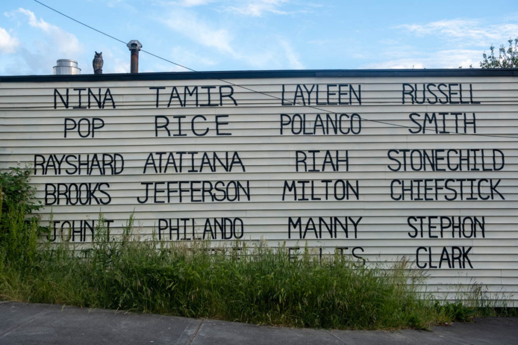 The names of victims of hate crime and police brutality span across the side of the Royal Room’s wall in Seattle’s Columbia City