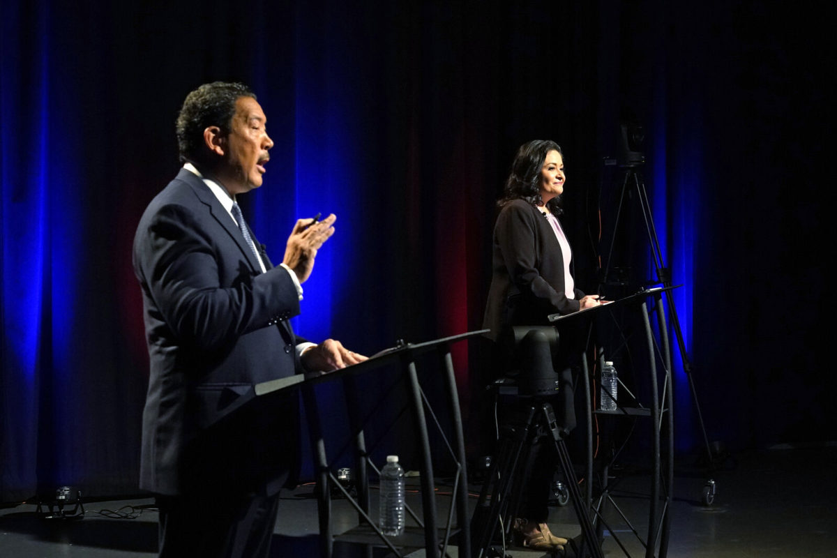 Bruce Harrell, left, answers a question as Lorena Gonzalez listens Thursday, Oct. 28, 2021, in Seattle during the second of two debates before the November election for the office of mayor.