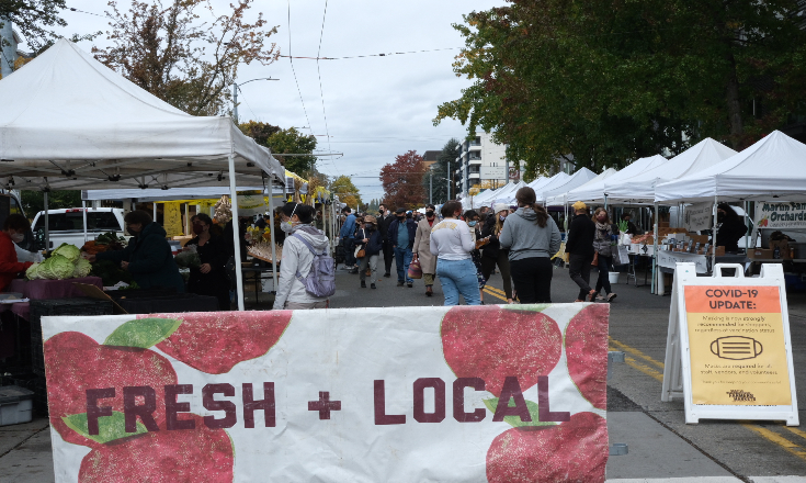Shoppers line the street to buy from and support their local farmers.