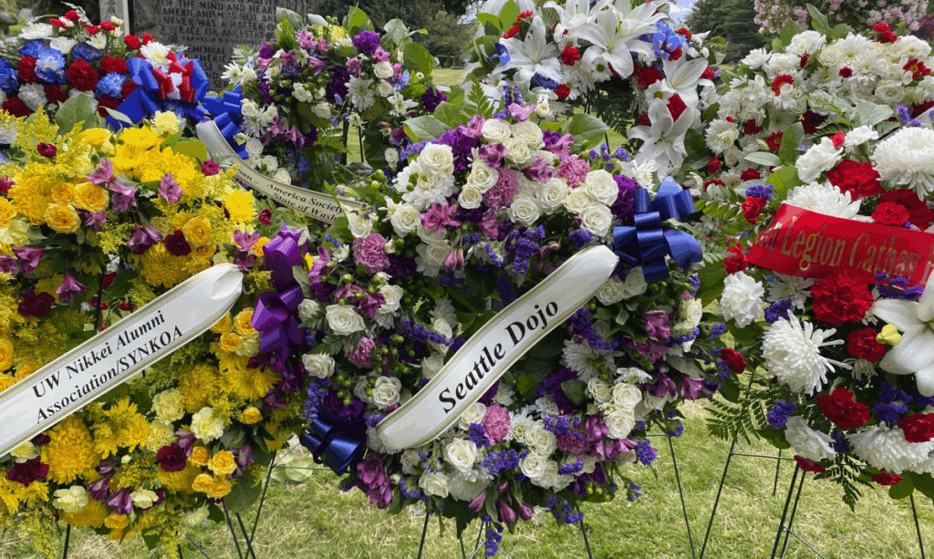Flower arrangements from various Seattle .groups commemorate the 80th annual Memorial Day service