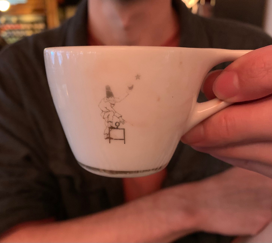 Macchiato cup decorated with a punchinello clown.