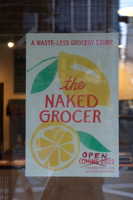 The Naked Grocer’s window sign, beckoning in customers from Capitol Hill.
