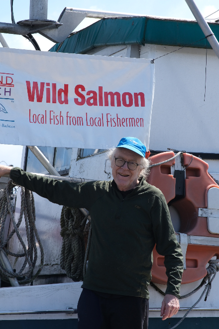 Knutson, an advocate for supporting local, poses on his fishing boat.