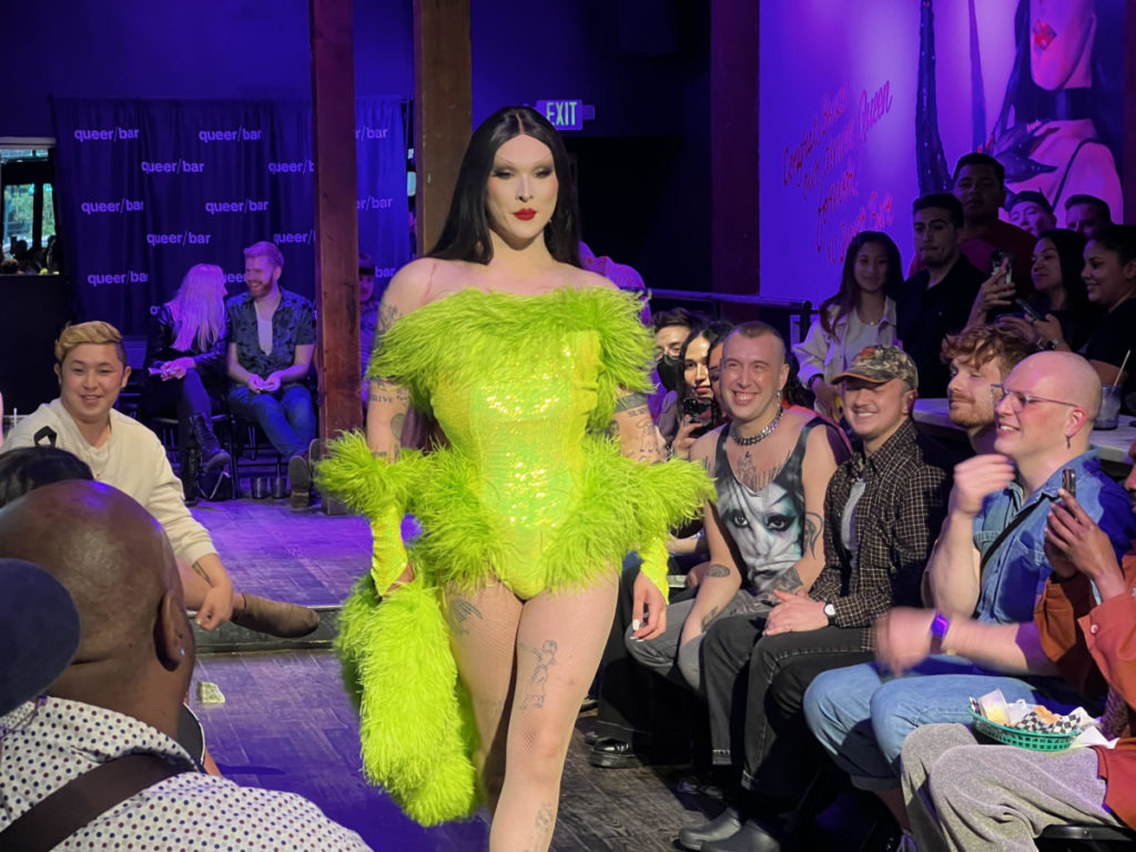 The Asian Fashion queen, Roman Ruthless, stuns audience with her neon green ostrich-feathered corset.